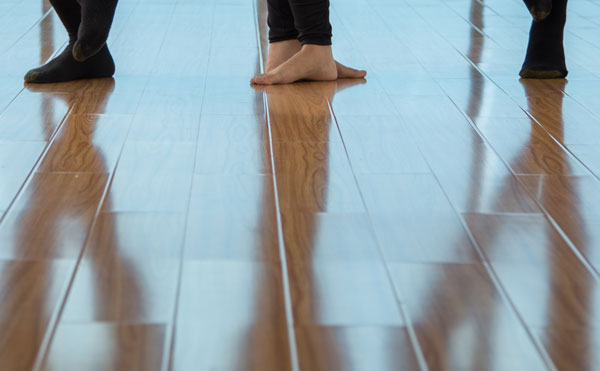 wooden floor reflection of people standing